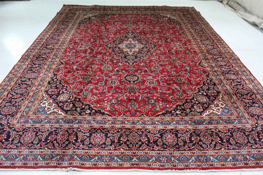 Full view of an ornate red Persian rug with an elaborate central medallion and intricate border. www.homelooks.com