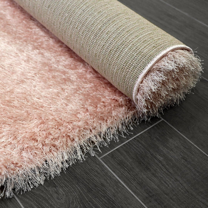 Lily Shimmer Blush Pink Shaggy Rug rolled up www.homelooks.com