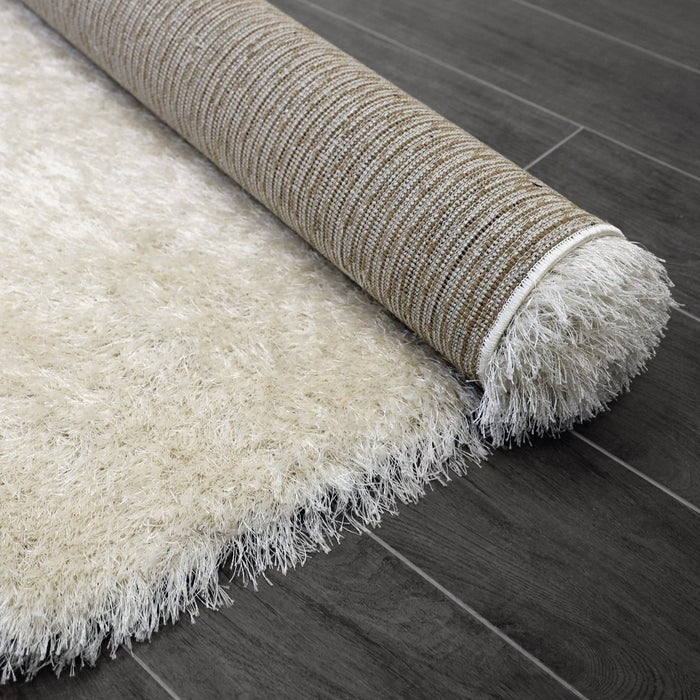 Lily Shimmer Cream Shaggy Rug rolled up www.homelooks.com