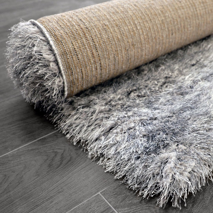 Lily Shimmer Grey Shaggy Rug rolled up www.homelooks.com