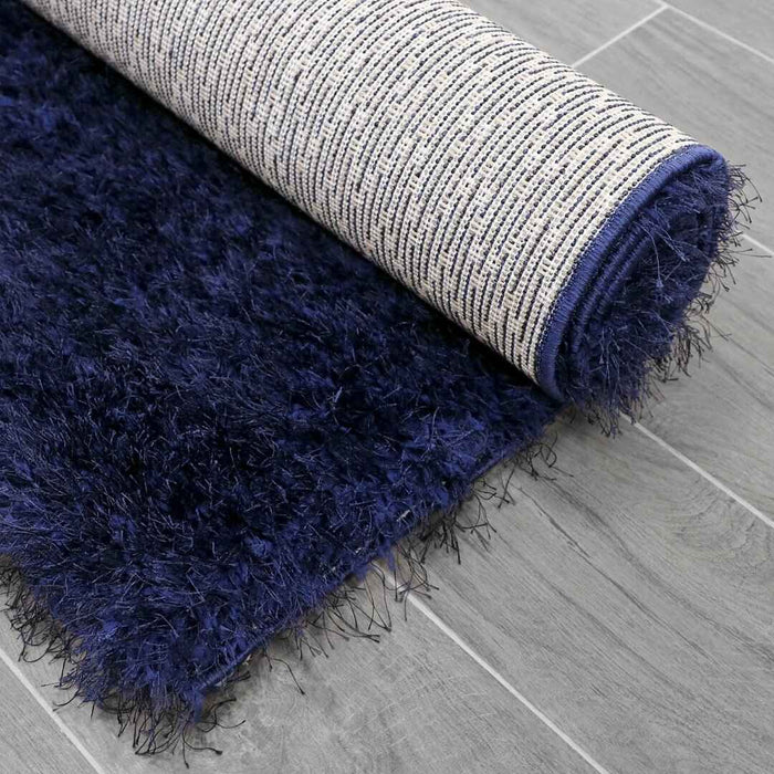 Lily Shimmer Navy Shaggy Rug folded www.homelooks.com