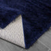 Lily Shimmer Navy Shaggy Rug folded www.homelooks.com