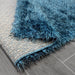 Lily Shimmer Turquoise Shaggy Rug folded www.homelooks.com