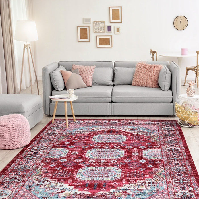 Cozy home interior with Amsterdam Medallion Rug, grey couch, and soft pink accents in a well-lit room- Red 6 - www.homelooks.com
