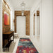 Amsterdam Paradise design runner rug in a hallway with brick walls, adding a splash of color to the home entryway www.homelooks.com