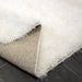 Lily Shimmer White Shaggy Rug folded www.homelooks.com