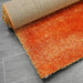 Puffy Shimmer Orange Shaggy Rug folded www.homelooks.com